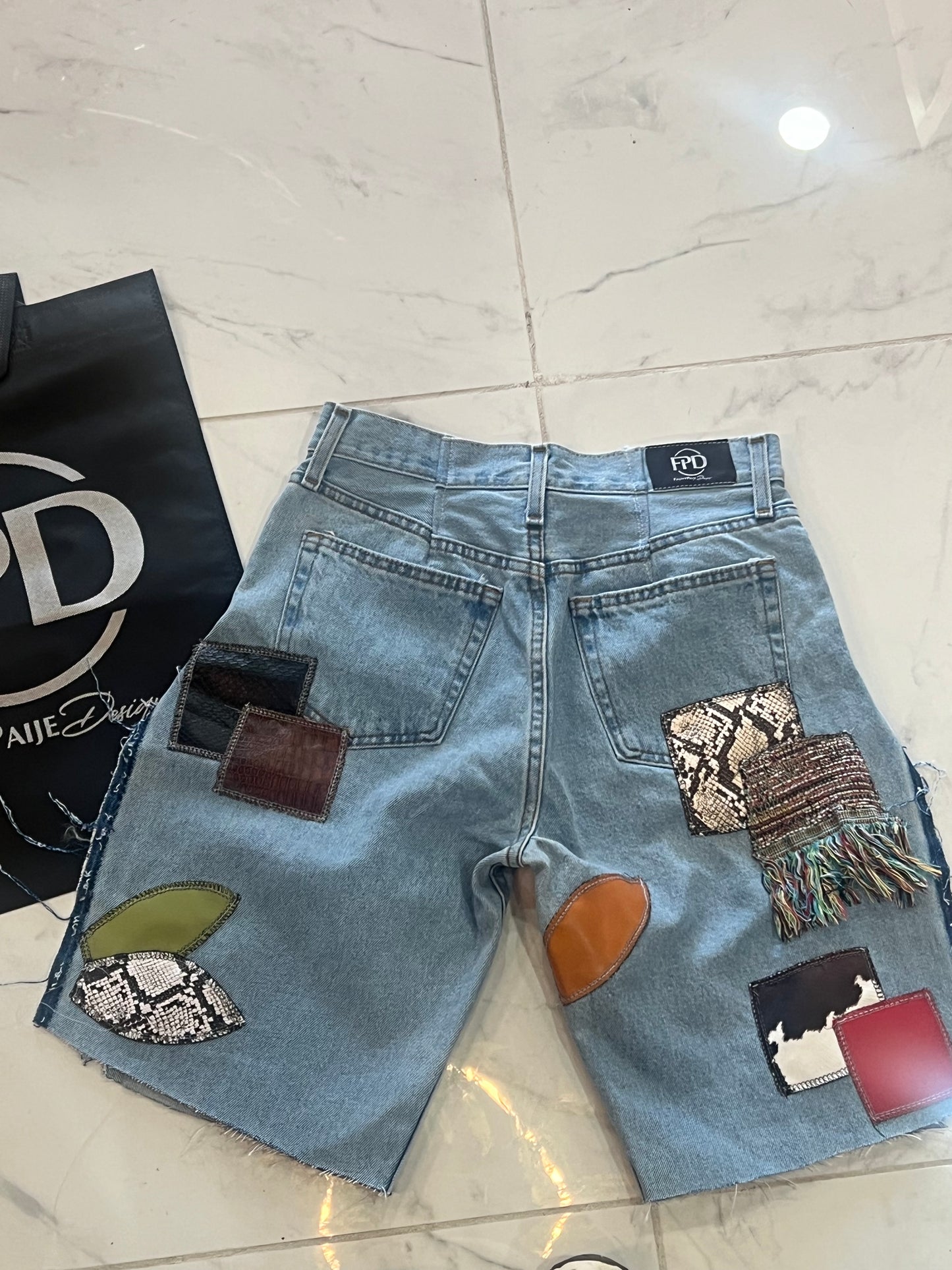 Patchwork light blue denim shorts